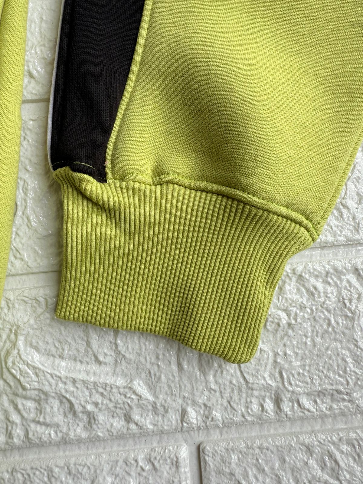 Vibrant Hilfiger 1985 hoodie with bold red and black stripe detailing for a sporty, stylish look.